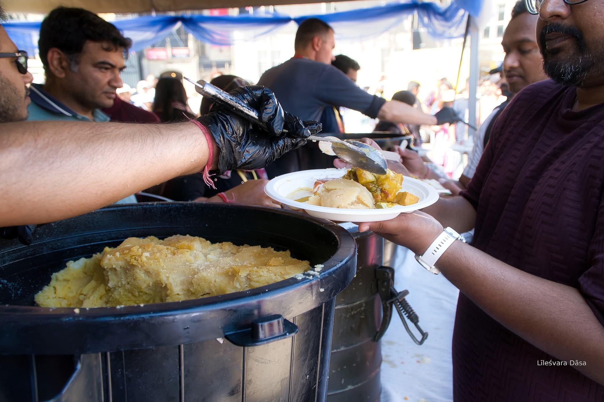 Volunteers serving free vegetarian prasadam at Ratha Yatra Amsterdam