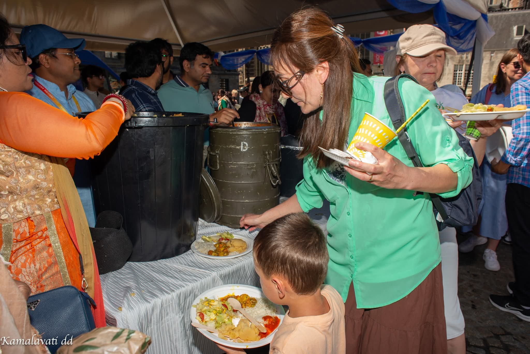 Volunteers serving free vegetarian prasadam at Ratha Yatra Amsterdam